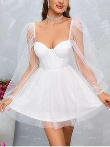 Detailed close-up of semi-transparent organza puff sleeves on white corset mini dress
