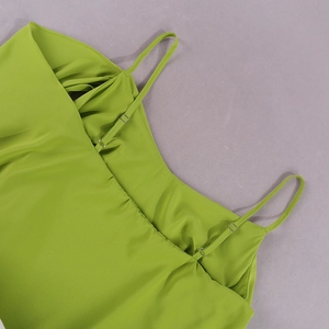 Detail of lime green chiffon dress showing adjustable spaghetti straps and ruffled neckline