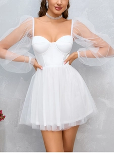 Detail of white mesh puff sleeves and strapless satin bodice on a mini dress