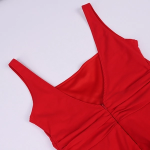 Detail of red dress back showing deep V-cut, invisible zipper, and ruching texture