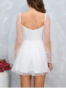 Detail of white mesh puff sleeves and back invisible zipper on the mesh dress