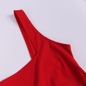 Detail shot of the shoulder strap stitching and red chiffon fabric texture on dress