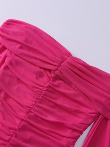 Detail view of pink mesh dress with dense horizontal ruched fabric and layered texture