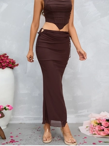 Detailed texture of dark brown mesh fabric and drawstring waist of the fishtail skirt