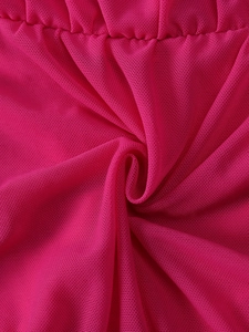 Close-up of pink mesh fabric texture with elegant pleats and breathable weave detail