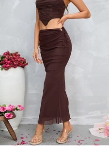 Detail of side drawstring and ruched texture on a brown mesh fishtail skirt