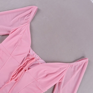 Detail of pink mesh dress featuring a deep V-neckline with adjustable drawstring and pleats