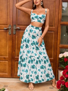 Detail of floral two-piece set with crop top and long tiered skirt against wooden door