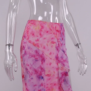 Detail view of pink floral skirt featuring side ruffle hem and side slit design