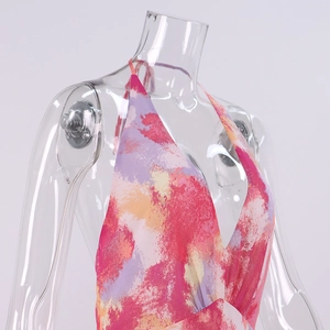 Macro shot of deep V-neck halter dress featuring vibrant red and pink watercolor floral print