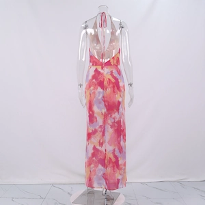 Detail of the backless halter maxi dress featuring abstract pink and purple splash prints
