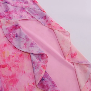 Detail of pink floral maxi skirt with side slit, silky lining and ruffled hem design