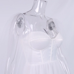 Close-up of white satin corset dress featuring boned structure and sheer mesh sleeves