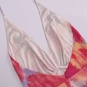 Close-up of mesh dress featuring deep V-neckline, tie-dye print, and invisible zipper detail