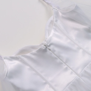 Detail of elegant white mesh dress featuring a sleek back invisible zipper and satin fabric