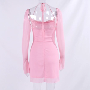 Close-up detail of pink mesh long sleeves and halter backless tie design on a slim dress