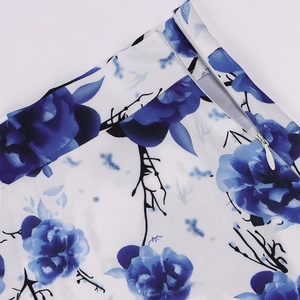 Close-up of invisible zipper detail on white dress with blue floral print fabric