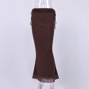 Detail view of the high waist ruffles and lace-up design on this brown maxi fishtail skirt