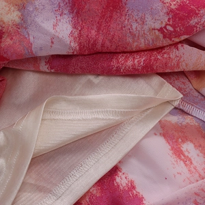Detail of multi-color watercolor mesh dress showing sewing craftsmanship and silky lining