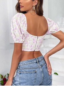 Detail view of the floral crop top with puff sleeves and metal zipper back closure