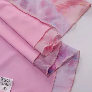 Detail of pink tie-dye mesh fabric layering with ruffled hem and knit lining material