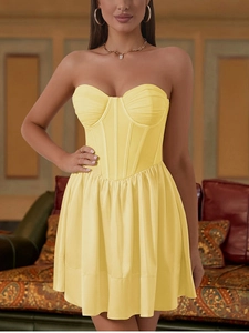 Detail of vibrant yellow mesh mini dress featuring corset boning and pleated bust design