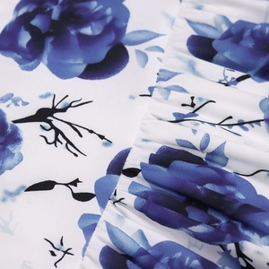 Close-up of floral print fabric with blue flowers and delicate ruffle detail