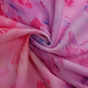 Detail view of pink and purple tie-dye mesh fabric with breathable texture and soft drape