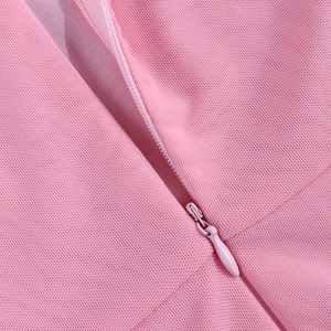 Close-up of the concealed zipper on the pink mesh dress featuring fine woven texture