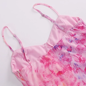 Detail of adjustable straps and floral mesh fabric on a sexy pink backless dress