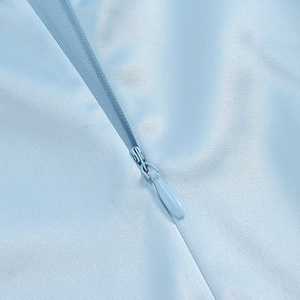 Close-up of invisible zipper detail on light blue satin backless summer dress