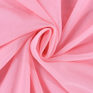 Detailed macro view of soft pink mesh fabric showing fine breathable texture and draping
