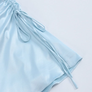 Detailed view of light blue satin dress with adjustable side drawstring and ruching