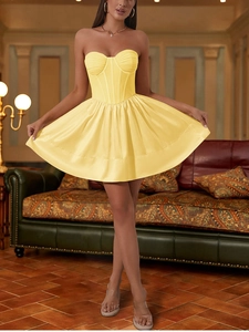 Detail of a bright yellow corset dress featuring mesh boning and a padded bustier design