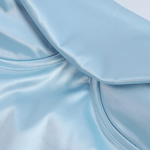 Close-up of light blue satin dress featuring structured corset cups and fine stitching