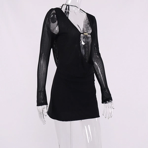 Detail of sheer mesh dress with deep V-neck and decorative golden metal buckles