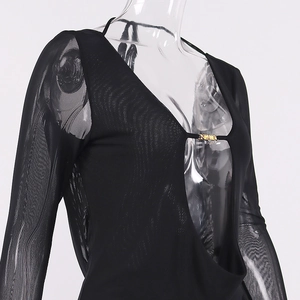 Detail of sheer black mesh top featuring deep V-neck and gold logo metal hardware