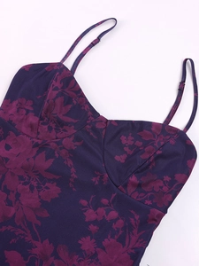Close-up of adjustable spaghetti strap and floral print detail on backless dress