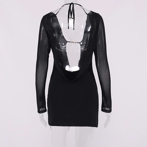 Detail of backless mini dress featuring draped cowl back and sheer mesh long sleeves
