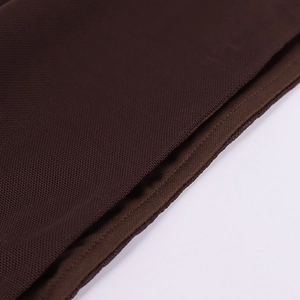 Macro view of dark brown knitted mesh fabric with honeycomb texture and flat stitching