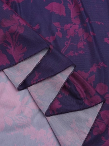 Close-up of purple floral mesh fabric showing detailed hem stitching and soft texture
