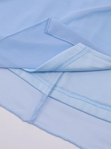 Close-up of high-quality stitching and breathable light blue mesh fabric on the dress