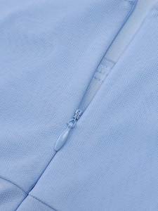Detailed macro view of the seamless invisible zipper on this light blue mesh maxi dress