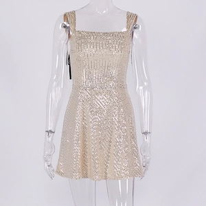 Close-up of champagne gold sequined dress with square neck and shimmering texture details