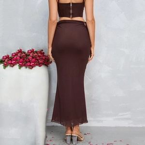 Women's back view of brown two-piece set featuring crop top and long mermaid maxi skirt