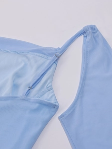 Detail of light blue mesh fabric featuring thin shoulder strap and silver metal adjuster