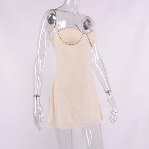 Detail of beige mesh party dress with sweetheart neckline and sparkling rhinestone trim