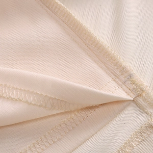 Macro shot of fine overlock stitching and mesh fabric texture on this summer dress
