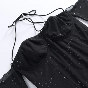 Détail de robe noire en résille avec paillettes argentées et encolure licou transparente