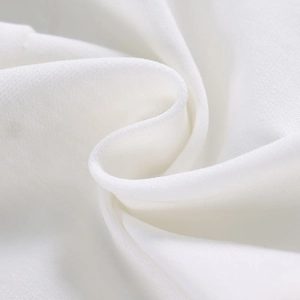 Primo piano del tessuto bianco con trama in crêpe morbido ed elegante drappeggio fluido
